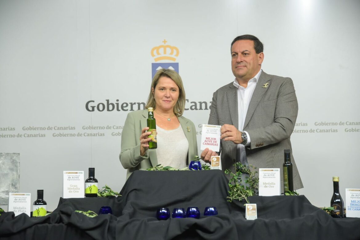 La consejera Alicia Vanoostende y el director del ICCA, Basilio Pérez muestran el aceite ganador